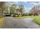 Well-maintained home with detached garage, circular driveway, and mature trees at 119 E End Ave, Statesville, NC 28677