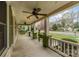 Relaxing covered front porch with ceiling fans and views of the neighborhood street at 119 E End Ave, Statesville, NC 28677