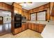 Bright kitchen boasting wood cabinetry, double ovens, and a convenient breakfast bar at 119 E End Ave, Statesville, NC 28677