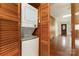 A close-up of a stackable washer and dryer inside a wood-paneled closet at 119 E End Ave, Statesville, NC 28677