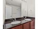 Bathroom features a double sink vanity with granite countertops, a large mirror, and neutral walls at 12550 Mcgrath Dr, Charlotte, NC 28269