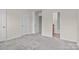 Spacious bedroom with neutral carpet, and access to ensuite bathroom at 12550 Mcgrath Dr, Charlotte, NC 28269