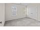 Cozy bedroom with two windows providing natural light and neutral carpet at 12550 Mcgrath Dr, Charlotte, NC 28269
