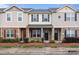 Charming townhome featuring stone accents, neutral siding, black shutters, and well-maintained landscaping at 12550 Mcgrath Dr, Charlotte, NC 28269