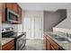 Functional kitchen with stainless steel appliances, granite counters, and ample cabinet space at 12550 Mcgrath Dr, Charlotte, NC 28269