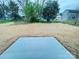 A concrete patio slab with newly laid straw in a backyard with a tree line at 1406 Mason St, Kannapolis, NC 28081