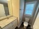 Bright bathroom featuring granite countertop, white vanity, and window with natural light at 1406 Mason St, Kannapolis, NC 28081