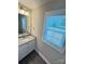 Bathroom featuring a gray countertop, modern sink, and bright natural lighting at 1406 Mason St, Kannapolis, NC 28081