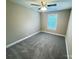Neutral bedroom with gray carpet and a ceiling fan, creating a cozy and relaxing atmosphere at 1406 Mason St, Kannapolis, NC 28081