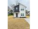 Front view of a charming two-story home with white siding, dark accents, and a welcoming front porch at 1406 Mason St, Kannapolis, NC 28081