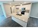 Bright kitchen with white cabinets, granite counters, stainless appliances, and a center island at 1406 Mason St, Kannapolis, NC 28081
