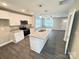 Open concept kitchen features stainless appliances and an island with granite countertops at 1406 Mason St, Kannapolis, NC 28081