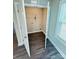 Small laundry area with a wire rack shelf, washer and dryer hookups, and wood look flooring at 1406 Mason St, Kannapolis, NC 28081