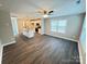 Open-concept living area with hardwood floors, a ceiling fan, and a view into the kitchen at 1406 Mason St, Kannapolis, NC 28081