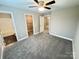 Main bedroom featuring an ensuite bathroom, walk-in closet, soft carpet, and neutral color scheme at 1406 Mason St, Kannapolis, NC 28081