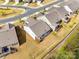Back aerial view of the property features manicured lawn, a patio, and lush landscaping at 1625 Carolina Orchards Blvd, Fort Mill, SC 29715
