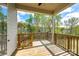 Cozy, covered back porch with wood flooring and railing offers scenic views and relaxing space at 1625 Carolina Orchards Blvd, Fort Mill, SC 29715