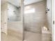 Contemporary bathroom featuring a glass-enclosed shower with tiled walls, a built-in bench, and tiled floors at 1625 Carolina Orchards Blvd, Fort Mill, SC 29715