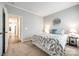 Bedroom with a comfortable bed, carpet flooring, and an open door leading to the hallway at 1625 Carolina Orchards Blvd, Fort Mill, SC 29715