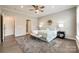 Bright primary bedroom with large windows, hardwood floors, and neutral decor at 1625 Carolina Orchards Blvd, Fort Mill, SC 29715