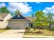 Charming single-story home with a well-manicured lawn, lovely landscaping, and a two-car garage at 1625 Carolina Orchards Blvd, Fort Mill, SC 29715