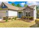 Detailed view of stone accents and landscaping enhance the curb appeal of this charming home at 1625 Carolina Orchards Blvd, Fort Mill, SC 29715