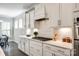Gourmet kitchen featuring white cabinetry, stainless steel appliances, and sleek countertops at 1625 Carolina Orchards Blvd, Fort Mill, SC 29715