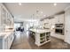Bright, open-concept kitchen with white cabinetry, stainless steel appliances, and a large center island with seating at 1625 Carolina Orchards Blvd, Fort Mill, SC 29715
