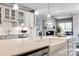 Bright kitchen features white cabinets, stainless steel appliances, and an island with a farmhouse sink at 1625 Carolina Orchards Blvd, Fort Mill, SC 29715