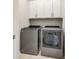 Laundry room featuring gray washer and dryer, with white cabinets above, and tile flooring at 1625 Carolina Orchards Blvd, Fort Mill, SC 29715