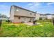 A fenced backyard featuring a concrete patio, grill, and plenty of green space, ideal for relaxing or entertaining at 200 Boysenberry Dr, China Grove, NC 28023