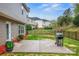 Spacious backyard features a concrete patio, grill, and a black metal fence, perfect for outdoor entertaining at 200 Boysenberry Dr, China Grove, NC 28023