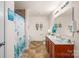 Bright bathroom featuring double vanity, framed mirror, and tub-shower combo with beach themed decor at 200 Boysenberry Dr, China Grove, NC 28023