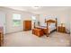 Comfortable bedroom featuring natural light, wooden furniture and ample space at 200 Boysenberry Dr, China Grove, NC 28023