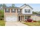 Charming two-story home with a well-manicured lawn and a spacious two-car garage at 200 Boysenberry Dr, China Grove, NC 28023