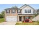 Charming two-story home with a well-manicured lawn and a spacious two-car garage at 200 Boysenberry Dr, China Grove, NC 28023