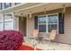 Inviting front porch with seating and landscaping, creating a cozy outdoor space at 200 Boysenberry Dr, China Grove, NC 28023