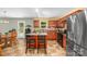 Inviting kitchen features an island with seating, stainless steel refrigerator, and tile flooring at 200 Boysenberry Dr, China Grove, NC 28023