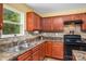 Kitchen features stainless steel sink, black appliances, and plenty of cabinet space at 200 Boysenberry Dr, China Grove, NC 28023