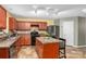 Well-lit kitchen showcasing an island with seating, black appliances, and plenty of counter space at 200 Boysenberry Dr, China Grove, NC 28023