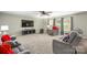 Open living room provides lots of seating, a ceiling fan, and a large TV at 200 Boysenberry Dr, China Grove, NC 28023