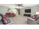 Comfortable living room is well-lit and features a ceiling fan and a large television at 200 Boysenberry Dr, China Grove, NC 28023