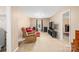 View of carpeted living room with a cozy couch, chair and a window at 200 Boysenberry Dr, China Grove, NC 28023