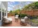 Backyard deck with outdoor seating and landscaping with wooden fence at 2005 Dunsmore Ln, Waxhaw, NC 28173