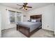 Bedroom features a modern ceiling fan, window with blinds, and a dark wood bed frame at 2005 Dunsmore Ln, Waxhaw, NC 28173