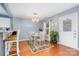 Bright dining area with hardwood floors, a chandelier, and an adjacent view of the kitchen at 2005 Dunsmore Ln, Waxhaw, NC 28173