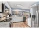 Bright kitchen featuring white cabinets, stainless steel appliances, and granite countertops at 2005 Dunsmore Ln, Waxhaw, NC 28173