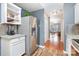 Kitchen showcasing stainless steel refrigerator, white cabinets, and an open layout to the dining area at 2005 Dunsmore Ln, Waxhaw, NC 28173