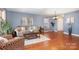 Inviting living room with hardwood floors, soft blue walls, and cozy seating arrangements at 2005 Dunsmore Ln, Waxhaw, NC 28173