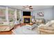 Bright living room with a fireplace, large windows, and comfortable seating area at 2005 Dunsmore Ln, Waxhaw, NC 28173